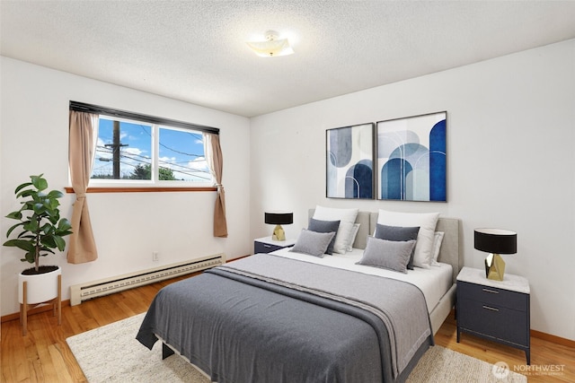 1642 Browns Point Blvd, Tacoma, WA 98422 - bedroom with a baseboard radiator, light wood-style flooring, a textured ceiling, and baseboards