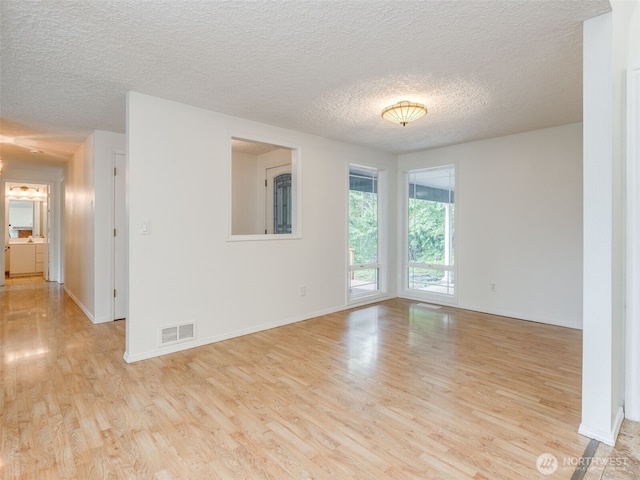 22414 NE 200th St, Brush Prairie, WA 98606 - spare room with light wood-style floors, a textured ceiling, and baseboards