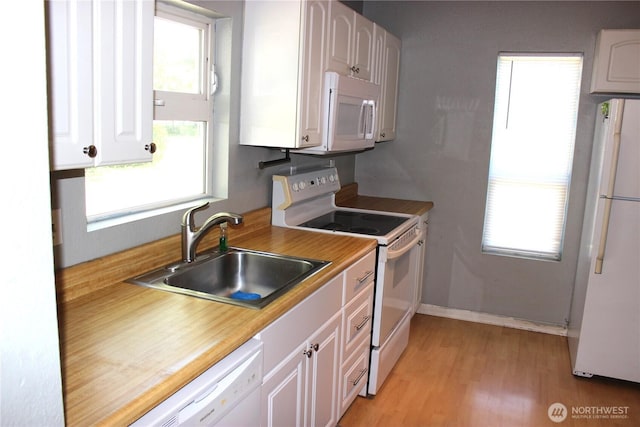 18343 Albany St SW, Rochester, WA 98579 - kitchen with white appliances, a sink, plenty of natural light, and white cabinetry