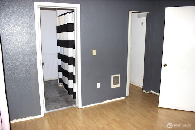 18343 Albany St SW, Rochester, WA 98579 - empty room featuring wood finished floors, heating unit, and baseboards