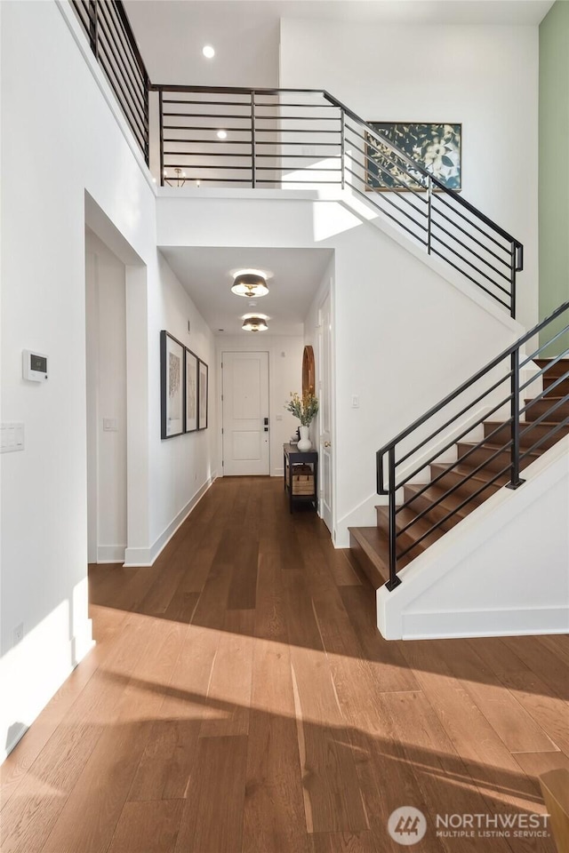 15306 204th Ave E Unit 23, Bonney Lake, WA 98391 - foyer featuring wood finished floors, a high ceiling, stairs, baseboards, and recessed lighting