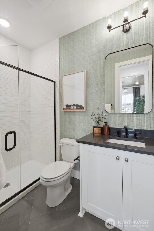 15306 204th Ave E Unit 23, Bonney Lake, WA 98391 - bathroom featuring vanity, toilet, a shower stall, tile patterned flooring, and wallpapered walls