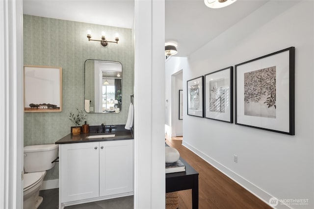 15306 204th Ave E Unit 23, Bonney Lake, WA 98391 - bathroom with toilet, vanity, wood finished floors, and baseboards