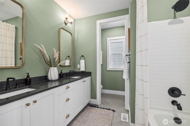 15306 204th Ave E Unit 23, Bonney Lake, WA 98391 - full bath featuring double vanity, baseboards, shower / bathtub combination with curtain, and toilet