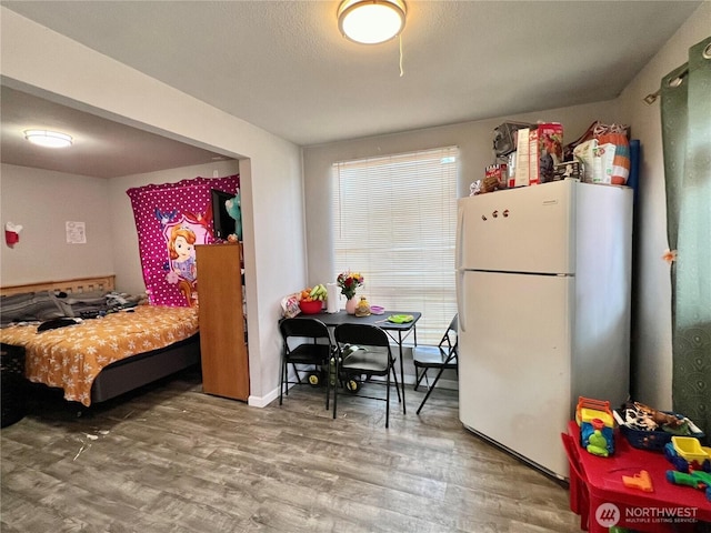 8040 Pacific Ave, Tacoma, WA 98408 - bedroom featuring freestanding refrigerator and wood finished floors