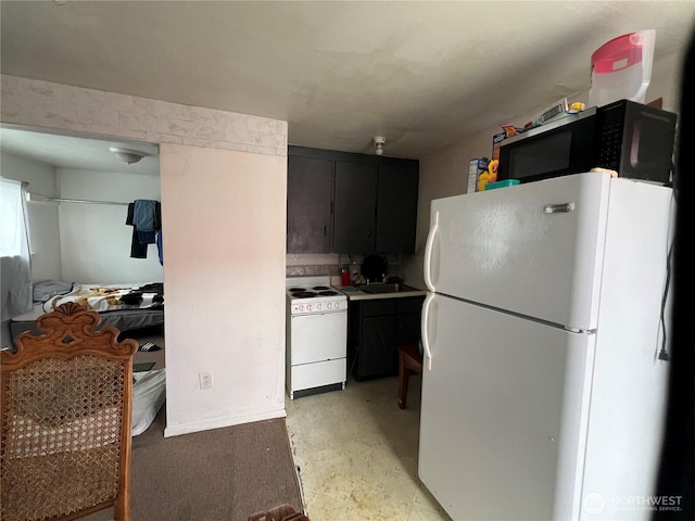8040 Pacific Ave, Tacoma, WA 98408 - kitchen with white appliances, dark cabinets, and light countertops