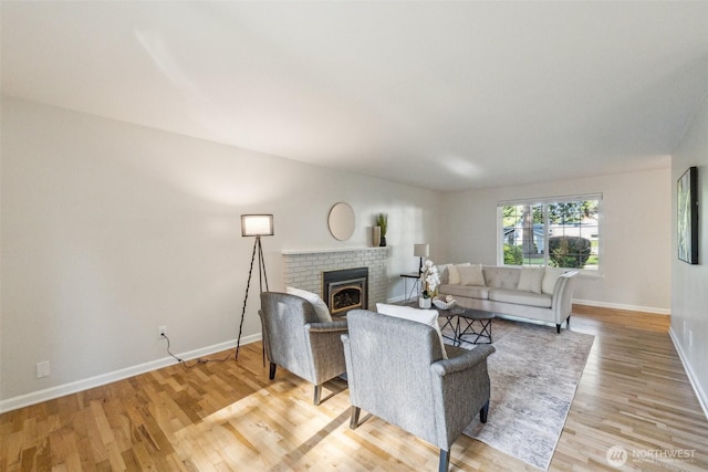 7309 134th Ave NE, Redmond, WA 98052 - living area featuring baseboards, light wood-style floors, and a brick fireplace
