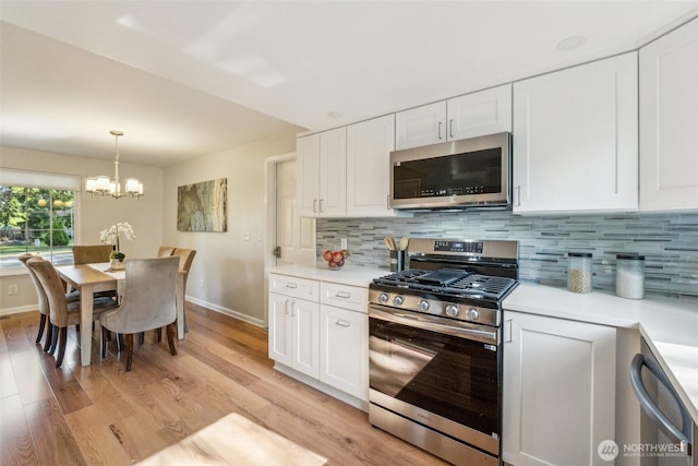 7309 134th Ave NE, Redmond, WA 98052 - kitchen featuring stainless steel appliances, baseboards, light wood-type flooring, and white cabinets
