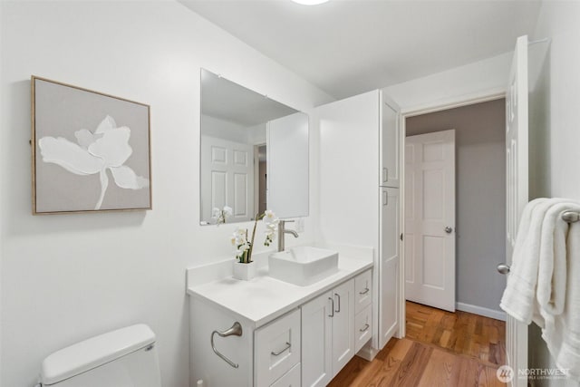 7309 134th Ave NE, Redmond, WA 98052 - half bath with vanity, wood finished floors, and toilet