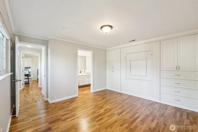 7309 134th Ave NE, Redmond, WA 98052 - unfurnished bedroom featuring light wood finished floors, crown molding, baseboards, and a closet
