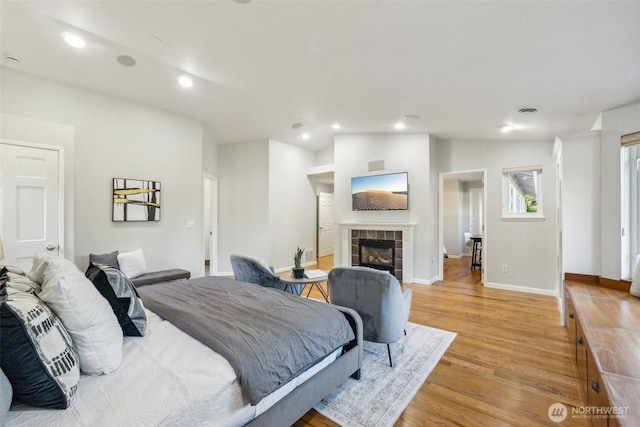 7309 134th Ave NE, Redmond, WA 98052 - bedroom with recessed lighting, light wood-style floors, a fireplace, and baseboards