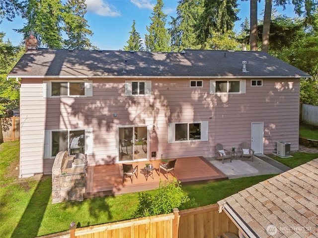 7309 134th Ave NE, Redmond, WA 98052 - rear view of house with a wooden deck, central AC unit, a chimney, and roof with shingles