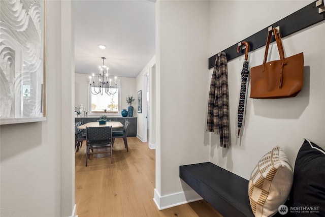 15310 204th Ave E Unit 22, Bonney Lake, WA 98391 - corridor with a chandelier, wood finished floors, and baseboards