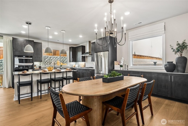 15310 204th Ave E Unit 22, Bonney Lake, WA 98391 - dining area with light wood-style flooring, a chandelier, and recessed lighting
