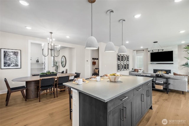 15310 204th Ave E Unit 22, Bonney Lake, WA 98391 - kitchen featuring light wood finished floors, a center island, light countertops, hanging light fixtures, and recessed lighting
