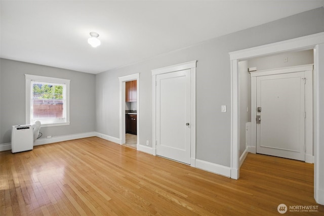 2132 5th Ave Unit 209, Seattle, WA 98121 - unfurnished bedroom featuring light wood-style flooring and baseboards
