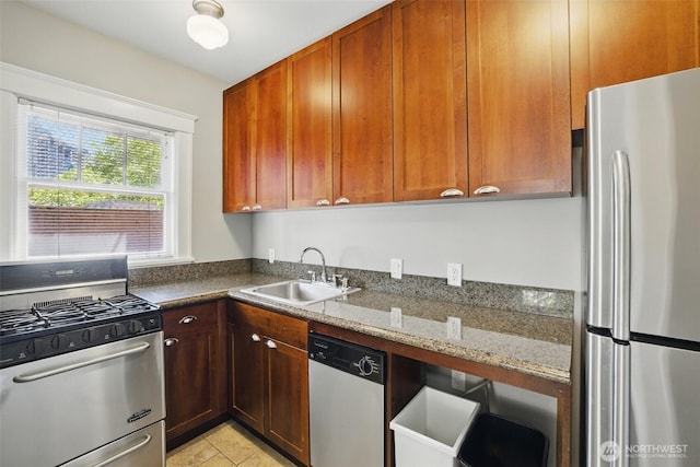 2132 5th Ave Unit 209, Seattle, WA 98121 - kitchen featuring stainless steel appliances, a sink, dark stone countertops, and light tile patterned flooring