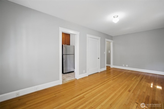 2132 5th Ave Unit 209, Seattle, WA 98121 - spare room with light wood-type flooring and baseboards