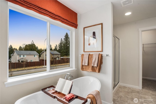 1192 68th Loop SE, Tumwater, WA 98501 - full bathroom with a shower stall, a walk in closet, a freestanding bath, baseboards, and recessed lighting