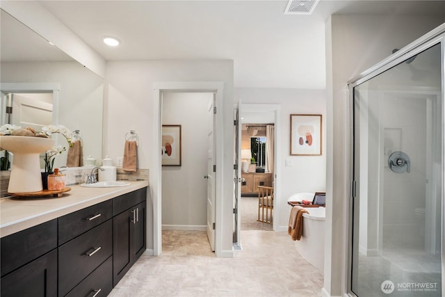 1192 68th Loop SE, Tumwater, WA 98501 - bathroom with a stall shower, a freestanding bath, vanity, and baseboards