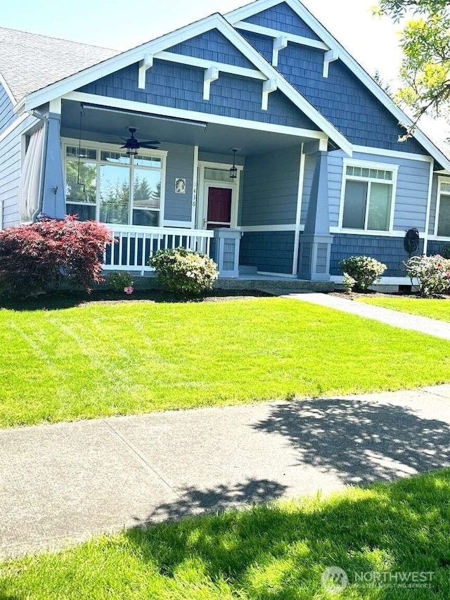 1436 Latham Ct, Dupont, WA 98327 - view of front facade featuring covered porch and a front lawn