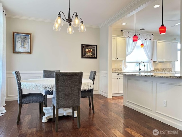 1436 Latham Ct, Dupont, WA 98327 - dining space featuring dark wood-style floors, a chandelier, ornamental molding, a wainscoted wall, and a decorative wall