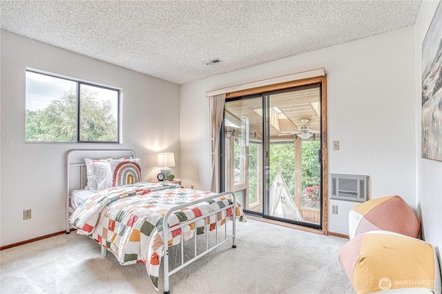 27 Poplar Ave, Wenatchee, WA 98801 - carpeted bedroom featuring access to exterior, multiple windows, a textured ceiling, and baseboards