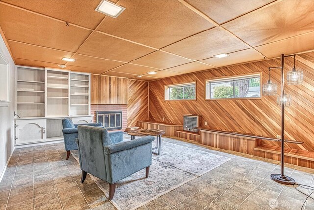 27 Poplar Ave, Wenatchee, WA 98801 - sitting room featuring wooden walls, built in shelves, and a brick fireplace