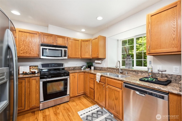 78 Honeycomb Ln, Bellingham, WA 98229 - kitchen with stainless steel appliances, light wood finished floors, recessed lighting, light stone counters, and brown cabinetry