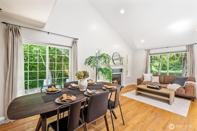 78 Honeycomb Ln, Bellingham, WA 98229 - dining space featuring high vaulted ceiling, a lit fireplace, light wood-type flooring, and recessed lighting