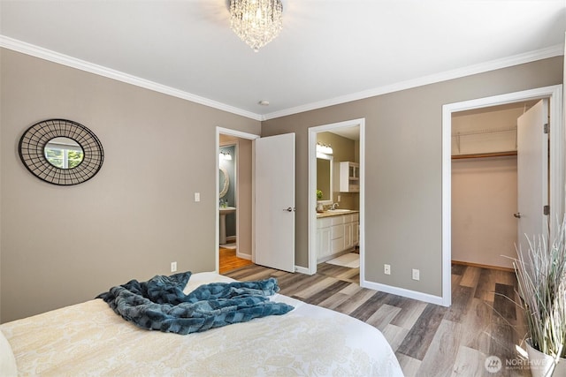 78 Honeycomb Ln, Bellingham, WA 98229 - bedroom with light wood-type flooring, a walk in closet, ornamental molding, ensuite bath, and a chandelier