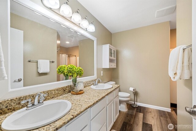 78 Honeycomb Ln, Bellingham, WA 98229 - full bath with wood finished floors, double vanity, and a shower with shower curtain