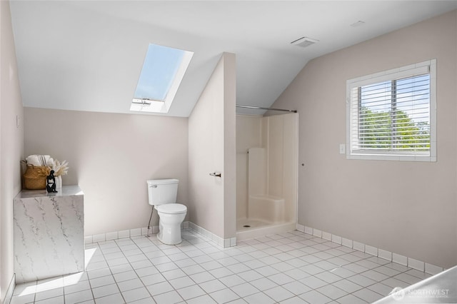 1306 E 32nd St, Tacoma, WA 98404 - bathroom featuring a skylight, lofted ceiling, toilet, a shower, and baseboards