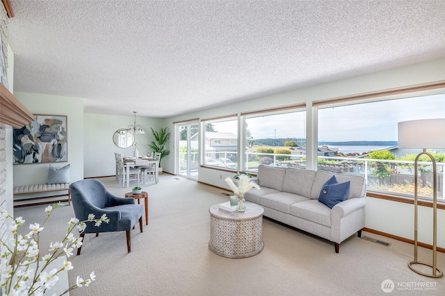7215 N 23rd, Tacoma, WA 98406 - living area with a chandelier, carpet flooring, a textured ceiling, and a water view