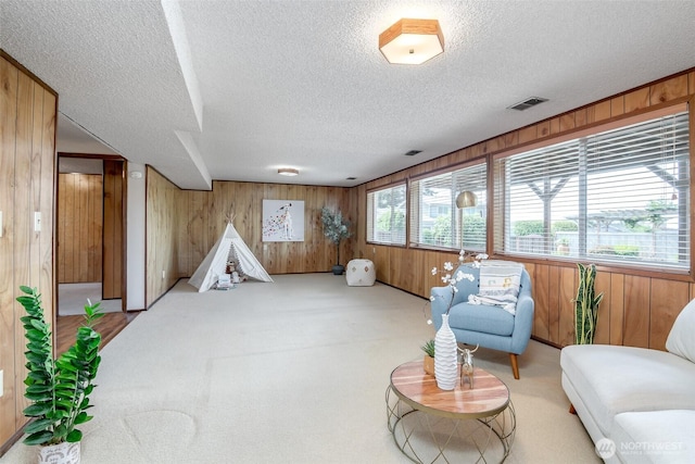 7215 N 23rd, Tacoma, WA 98406 - living area featuring wood walls, a textured ceiling, and carpet flooring