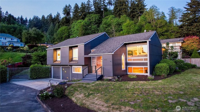 3932 202nd Pl SE, Sammamish, WA 98075 - view of front facade featuring concrete driveway, a garage, stucco siding, and a shingled roof