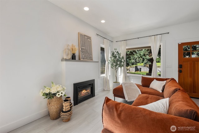 4642 Eastern Ave N, Seattle, WA 98103 - living area with recessed lighting, a glass covered fireplace, and light wood finished floors