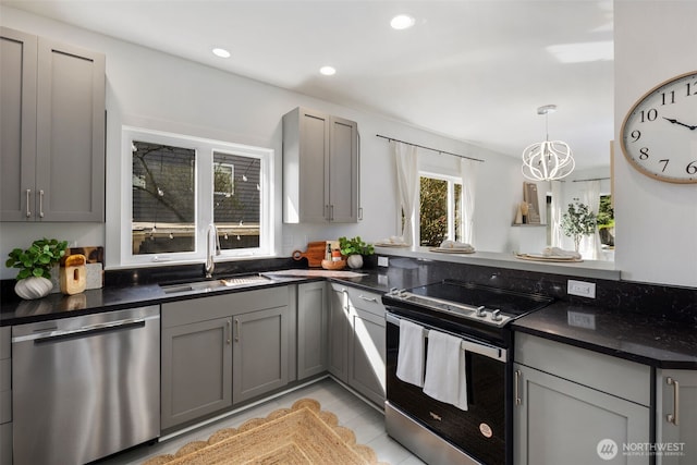 4642 Eastern Ave N, Seattle, WA 98103 - kitchen featuring stainless steel appliances, gray cabinets, a chandelier, recessed lighting, and decorative light fixtures