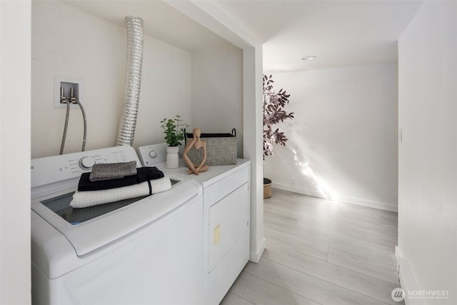 4642 Eastern Ave N, Seattle, WA 98103 - laundry room with washing machine and dryer and light wood-style flooring