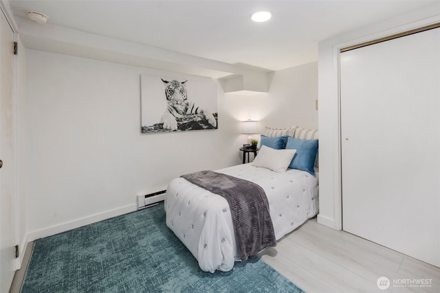 4642 Eastern Ave N, Seattle, WA 98103 - bedroom featuring baseboard heating, recessed lighting, a closet, and wood finished floors