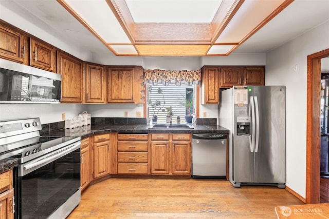 32232 7th Ave SW, Federal Way, WA 98023 - kitchen with stainless steel appliances, a sink, tile countertops, light wood-style flooring, and brown cabinetry