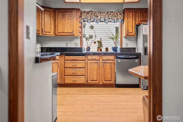 32232 7th Ave SW, Federal Way, WA 98023 - kitchen featuring appliances with stainless steel finishes, light wood-type flooring, and brown cabinetry