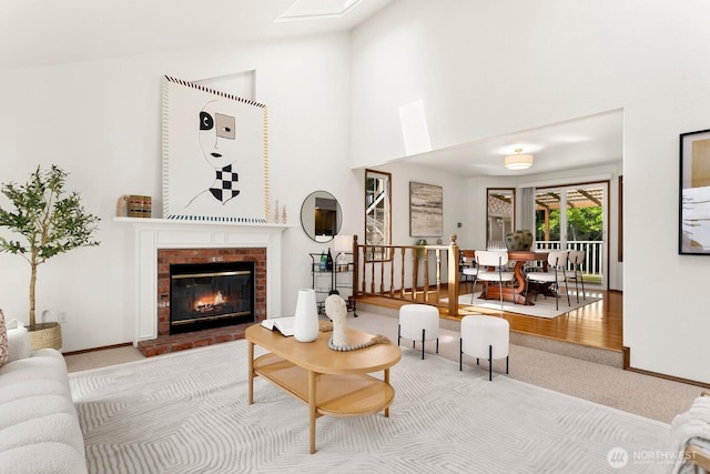 29617 58th Pl S, Auburn, WA 98001 - carpeted living room with a brick fireplace, high vaulted ceiling, and baseboards