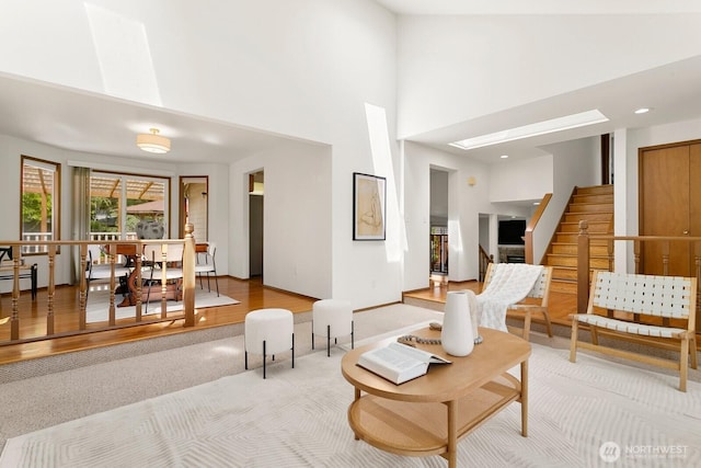 29617 58th Pl S, Auburn, WA 98001 - living area featuring a high ceiling, light colored carpet, stairs, and baseboards