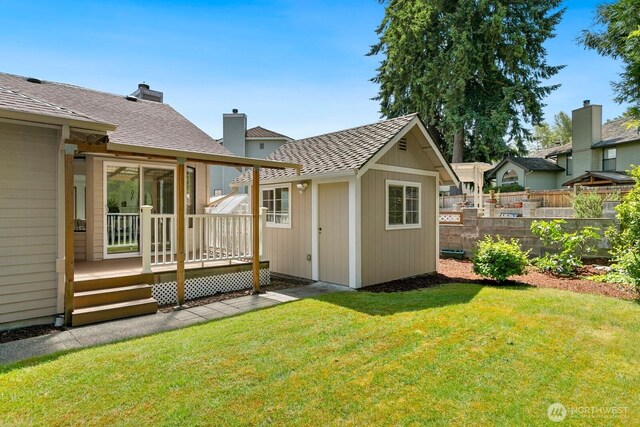 29617 58th Pl S, Auburn, WA 98001 - back of house featuring an outdoor structure, a deck, a chimney, and roof with shingles
