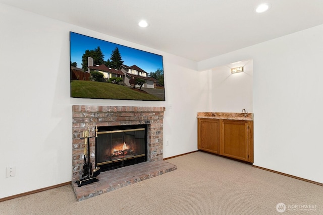 29617 58th Pl S, Auburn, WA 98001 - unfurnished living room with light colored carpet, a brick fireplace, baseboards, and recessed lighting