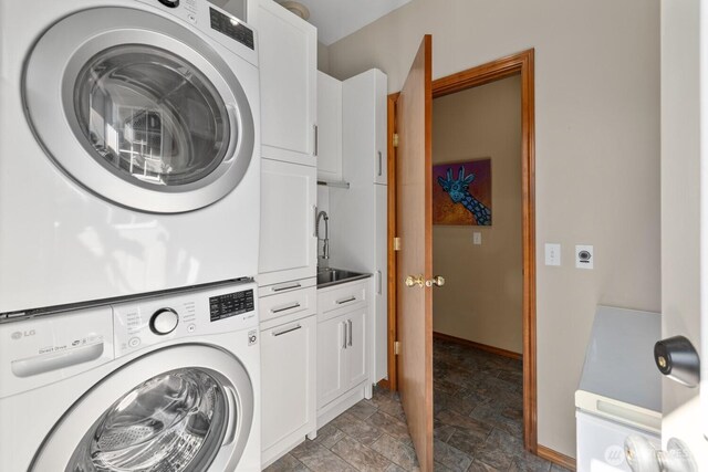 318 W Ridgeview Ln, Ellensburg, WA 98926 - washroom with stacked washer / dryer, cabinet space, stone finish flooring, and baseboards