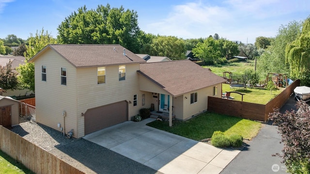 318 W Ridgeview Ln, Ellensburg, WA 98926 - traditional-style house with concrete driveway, roof with shingles, and a garage