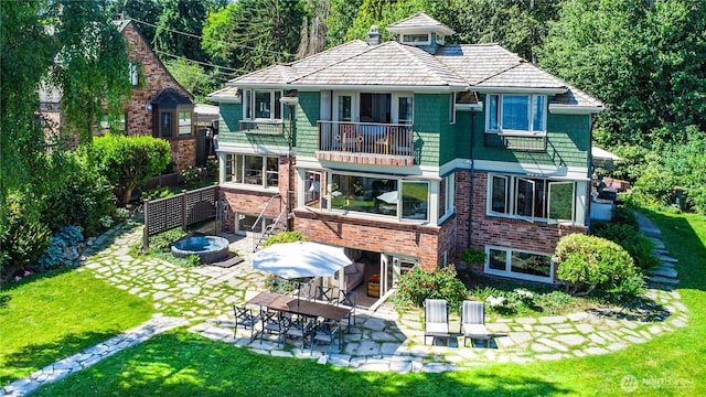 8314 Island Dr S, Seattle, WA 98118 - back of house with a patio, a balcony, a lawn, and brick siding