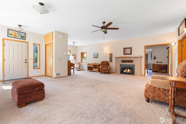 735 Coal Creek Rd, Chehalis, WA 98532 - living area with a fireplace with flush hearth, light carpet, a ceiling fan, and baseboards
